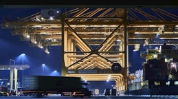 1920_nightviewofcranesandtrucksatjebelaliterminal
